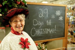 Counting down the days to Christmas, a woman greets visitors to a store during the Victorian Christmas on Main, Saturday Nov. 26, 2016, in Plattmouth, INE. (photo by Jerry L Mennenga©)